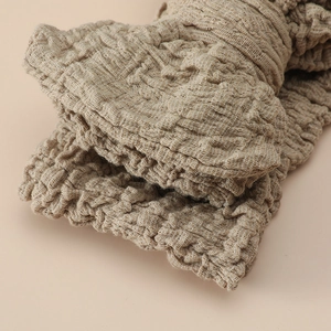 Elastic oversized bow headband with bubble textured fabric for baby girls in light brown