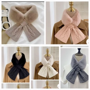 Detail of knitted winter scarf with faux fur trim and cable knit texture in various colors
