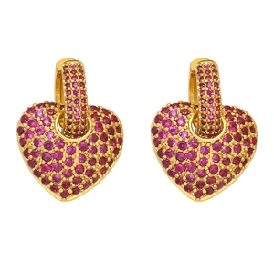 Macro detail of gold hoop earrings with pavé set pink heart-shaped zircon stones