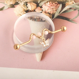 Golden wavy industrial barbell earring with crystal butterfly pendant and pink beads