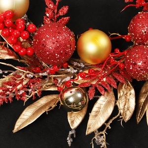 Christmas wreath with red glitter balls, matte gold spheres, berries, and velvet leaves
