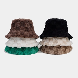 Detail of plush checkerboard bucket hats showing thick fleece texture in multiple colors