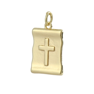 Macro view of a gold-plated scroll cross pendant with detailed religious relief