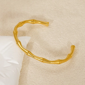Detailed view of 18K gold plated bamboo motif bangle with high polish finish