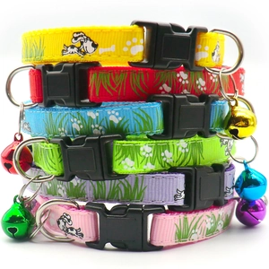 Detail of colorful nylon pet collars with bell, buckle and dog paw print pattern
