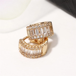 Macro shot of French luxury huggie earrings with baguette-cut and pave zircon stones
