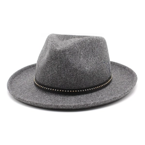 Detail of grey wool fedora hat featuring a thin black leather band with metallic studs