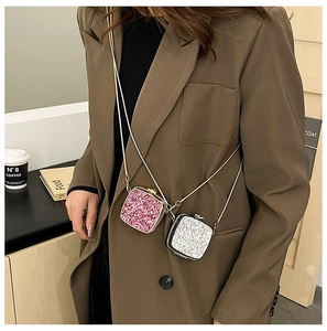 Mini acrylic glitter crossbody bags in pink and silver with delicate metal chain straps