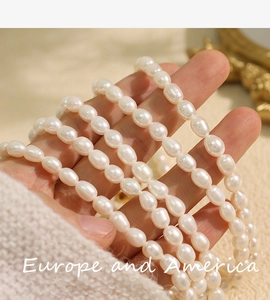 Detailed close-up of Baroque pearl necklace strand showing soft white luster