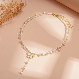 Elegant double-layer pearl necklace with gold butterfly pendant and zircon tassels