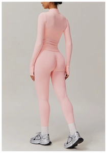 Detail of pink yoga set showing scrunch butt leggings and thumbhole sleeves design