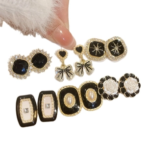 Vintage gold geometric earrings set with white pearls and black enamel floral accents