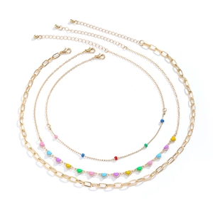 Detailed view of gold multi-layer necklace set with colorful heart charms and beads