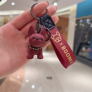 Detail of red French Bulldog keychain with leather strap and diamond collar