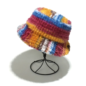 Close-up of colorful tie-dye faux fur bucket hat with long plush texture and vibrant stripes