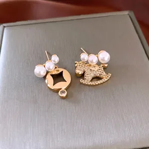 Asymmetric 18K gold-plated pearl horse drop earrings with sparkling cubic zirconia