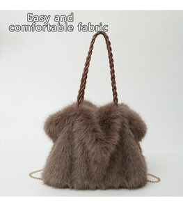 Close-up of brown faux fur tote bag with woven PU handle and golden chain strap detail