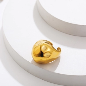 Detail view of gold hammer texture stainless steel chunky open ring on display stand