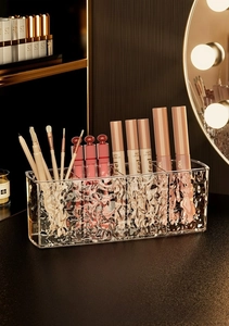 Macro shot of ripple textured acrylic cosmetic organizer for lipstick and makeup brushes