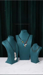 Three-piece set of dark blue velvet necklace display busts on white marble base