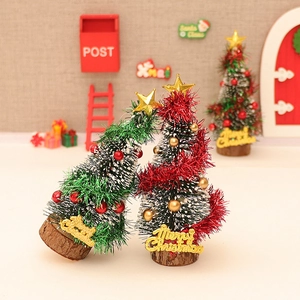 Miniature red and green Christmas trees with gold stars and wooden base models