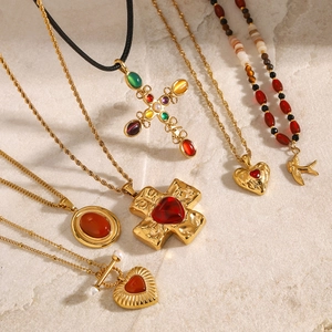 Set of six gold stainless steel necklaces with red agate cross and heart pendants