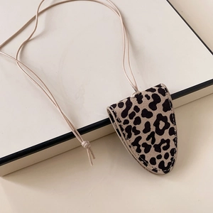 Close-up of leopard print faux leather pouch with soft texture and hanging cord
