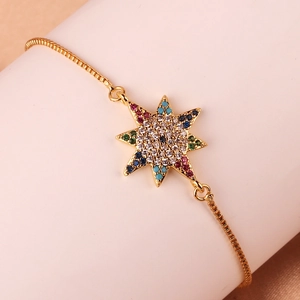 Macro shot of gold-plated box chain bracelet with colorful zircon star pendant detail