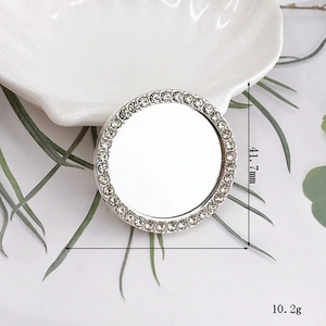 Detailed view of silver heart mirror accessory with diameter 41.7mm and rhinestones