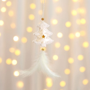 Close-up of white fabric Christmas tree hanging ornament with golden star and feathers