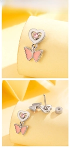 Detail of pink enamel butterfly heart earrings showing screw back design and zircons