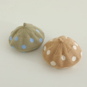 Detailed knit texture of autumn winter baby berets featuring stylish large polka dot patterns