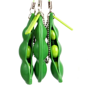 Three green edamame squeeze stress relief toys with bean pods and keychain chains