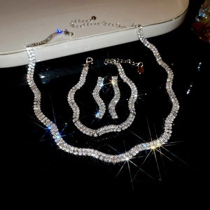 Sparkling silver wavy jewelry set including necklace, bracelet and earrings with rhinestones