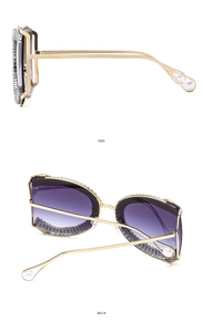 Detail of gold metal sunglasses with diamond inlay, purple gradient lenses and pearl tips