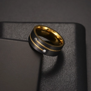 Macro detail of 8mm two-tone titanium ring with matte black surface and gold inlay