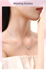 Detail of silver star pendant necklace with zircons shown on a female model neck