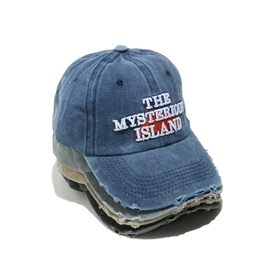 Washed denim baseball cap with Mysterious Island embroidery and distressed ripped details