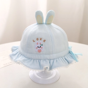 Detail of light blue baby sun hat with cute rabbit embroidery and lace brim edges