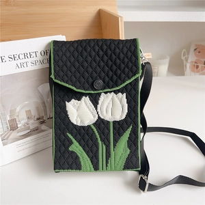 Detailed close-up of knitted mini bag showing tulip pattern and metallic strap buckle