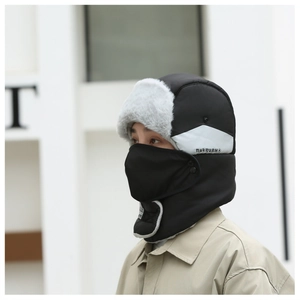 Side view of a thickened winter bomber hat with earflaps and integrated face mask