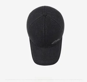 Top view of dark grey textured knit baseball cap with brand embroidery on light background