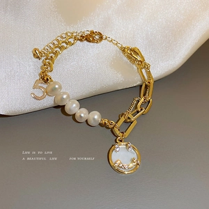 Asymmetric gold chain bracelet with pearls, rhinestone smiley face and number 5 pendant