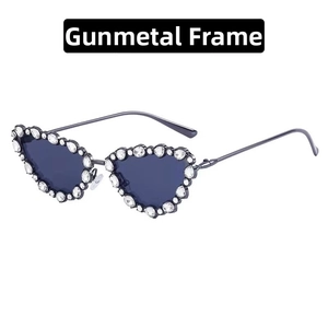 Detail of gunmetal heart-shaped sunglasses with crystal rhinestones and grey lenses