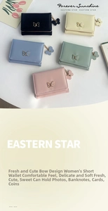 Close-up of small faux leather wallets with golden bow accents and multi-card slots