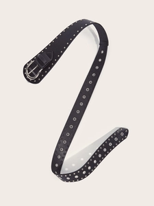 Detail of punk style black leather belt featuring silver metal rivets and eyelets