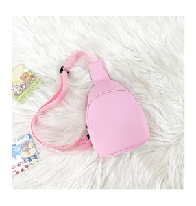 Pink cute mini crossbody bag with adjustable strap on white faux fur background