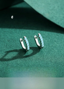 Close-up of S925 sterling silver earrings with five light blue turquoise stones