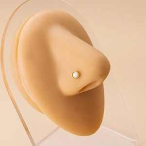 20G gold stainless steel L-shaped nose stud with white opal stone on a silicone model