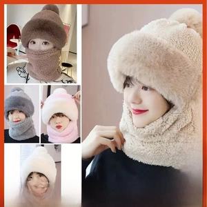 Detail of plush bear ear winter hat with pom-poms and integrated neck warmer scarf